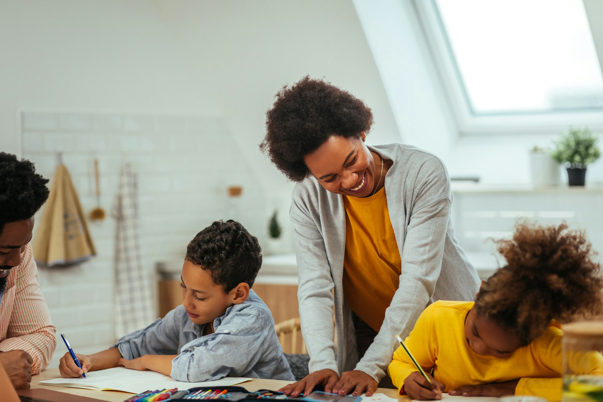 Afro parents helping their children with his homework